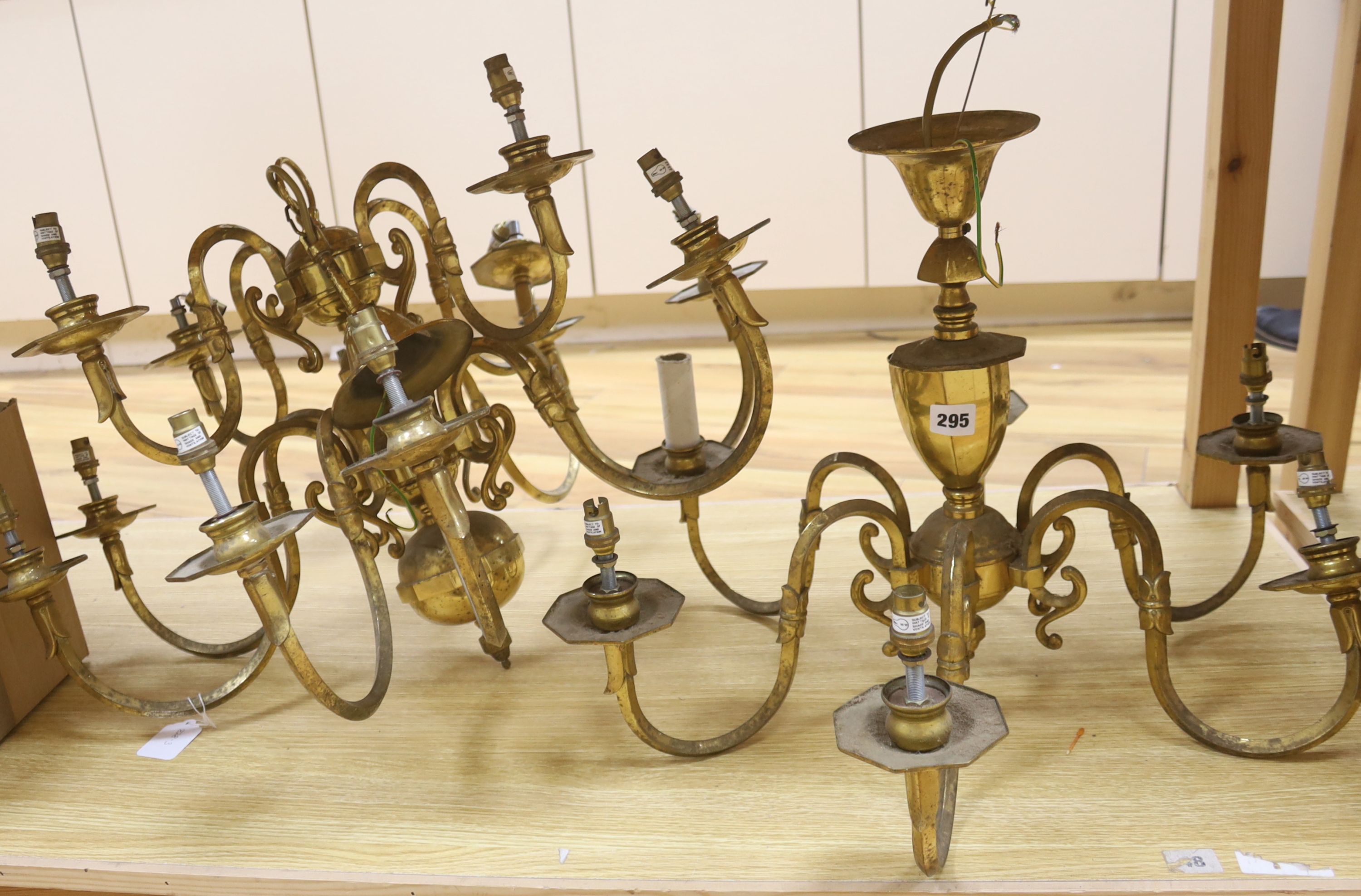 A brass two tier twelve branch electrolier and an associated six branch electrolier